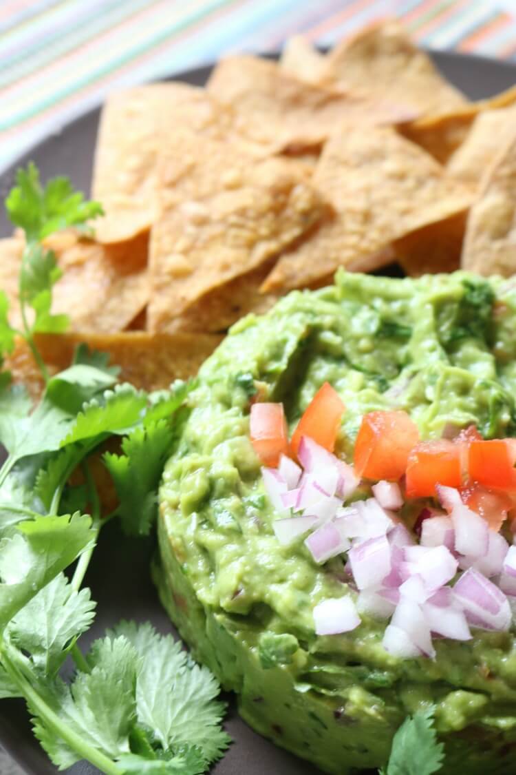 Chunky Guacamole is full of delicious flavors and textures. It's naturally gluten free and is a great dip for Paleo, GAPS or Whole30. Or enjoy with super easy homemade baked tortilla chips. 