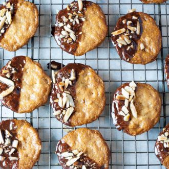 Almond Orange Cookies -With hints of orange zest, these crispy thin almond cookies are dunked in chocolate and topped with toasted almonds.  These Almond Orange Cookies are naturally gluten free, primal and GAPS with Paleo version.