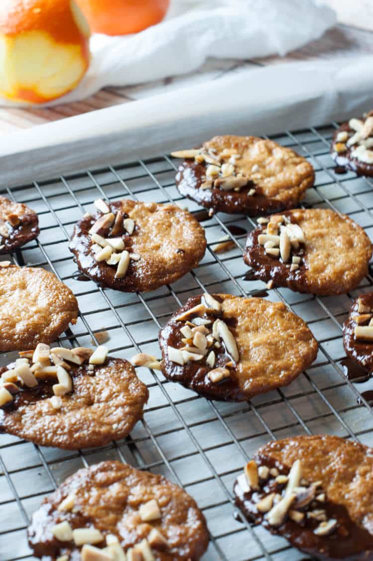 Almond Orange Cookies -Crispy thin almond cookies are dunked in chocolate ganache and topped with toasted almonds. These cookies are naturally gluten free, primal, paleo and GAPS. 