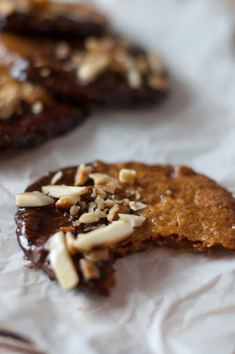 Almond Orange Cookies -With hints of orange zest, these crispy thin almond cookies are dunked in chocolate and topped with toasted almonds.  These Almond Orange Cookies are naturally gluten free, primal and GAPS with Paleo version.