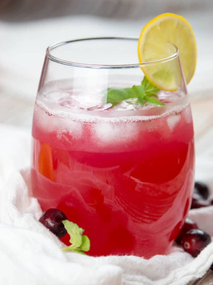 Healthy cranberry juice in a glass with ice and lemon slice