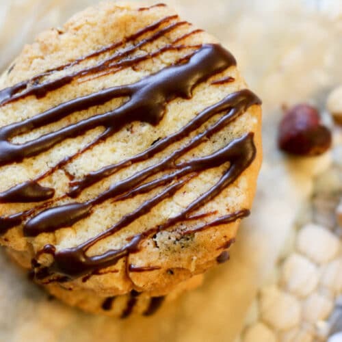 Keto Hazelnut Butter Cookies - These delicate, buttery cookies practically melt in your mouth. Roasted hazelnuts give them a nice crunch and a luscious drizzle of sugar-free chocolate takes these low carb treats over the top. #lowcarb #cookies #glutenfree