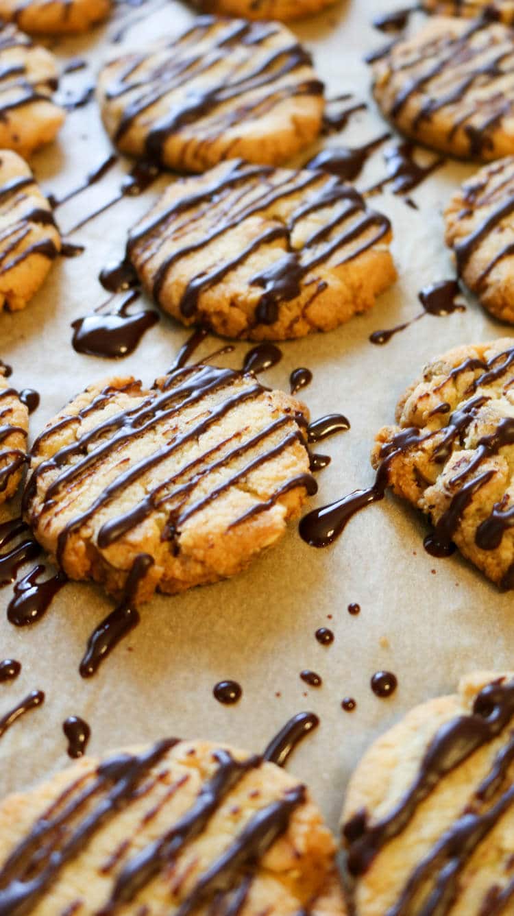 Keto Hazelnut Butter Cookies - These delicate, buttery cookies practically melt in your mouth. Roasted hazelnuts give them a nice crunch and a luscious drizzle of sugar-free chocolate takes these low carb treats over the top. #lowcarb #cookies #glutenfree