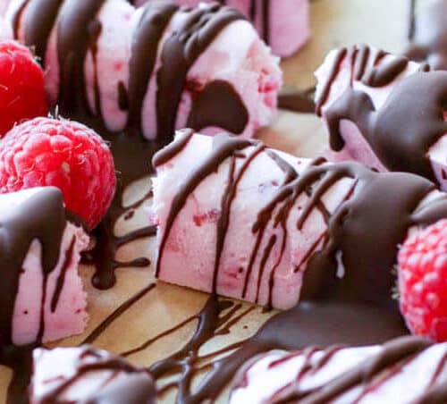 Keto Raspberry Cheesecake Fat Bombs - Raspberry Cheesecake Fat Bombs are made with 5 simple ingredients and are the perfect low-carb treat to satisfy your sweet tooth craving. #lowcarb #fatbombs