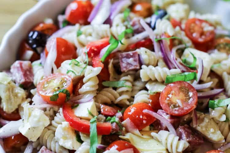 pasta salad with fussili, tomatoes, red onions, kalamata olives, and basil