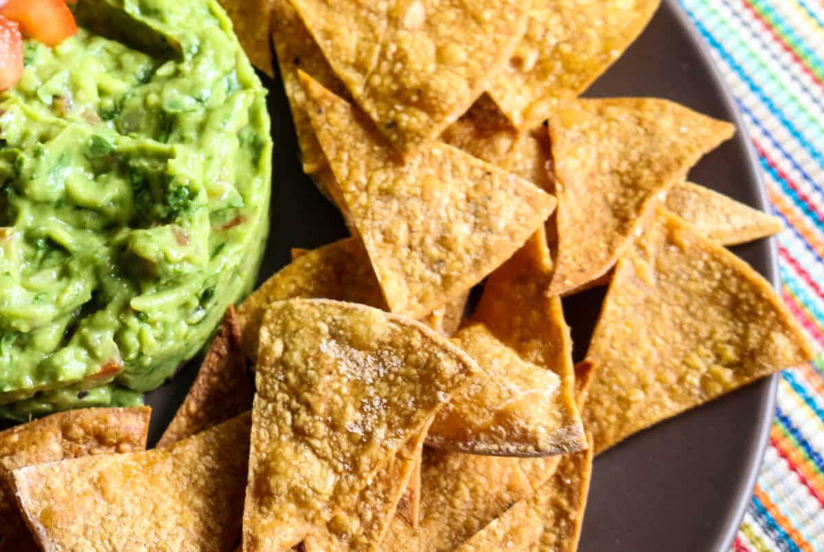 How to Make Healthy Tortilla Chips - 2 Ingredients! Check out how easy it is to make healthy, homemade tortillas that requires only 2 ingredients and 15 minutes of your time. Great to dip into chunky guacamole or pico de gallo. #homemadechips #tortillachips