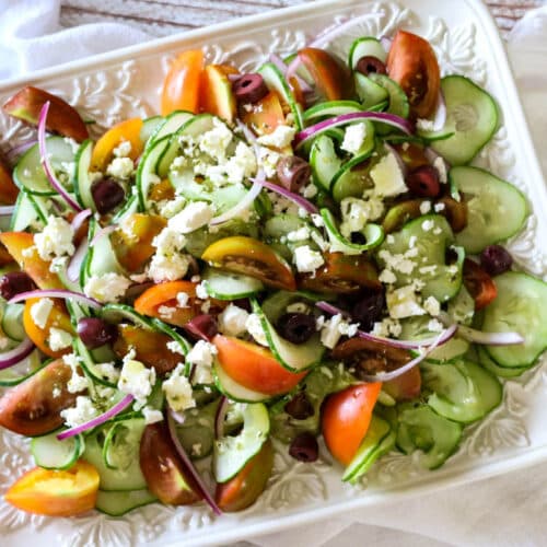 Greek Tomato & Cucumber Salad (Low Carb, Primal, GAPS) -This Greek Tomato and Cucumber Salad with or without feta cheese has all the robust Mediterranean flavors. With a simple 4-ingredient salad dressing, this salad can be made in 15 minutes. #healthysalad #greeksalad