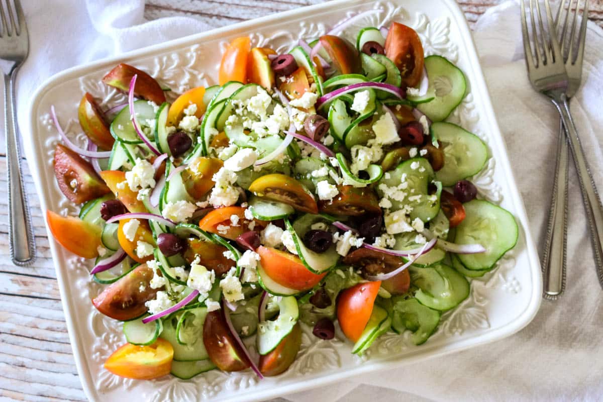 Greek Tomato & Cucumber Salad (Low Carb, Primal, GAPS) -This Greek Tomato and Cucumber Salad with or without feta cheese has all the robust Mediterranean flavors. With a simple 4-ingredient salad dressing, this salad can be made in 15 minutes. #healthysalad #greeksalad 