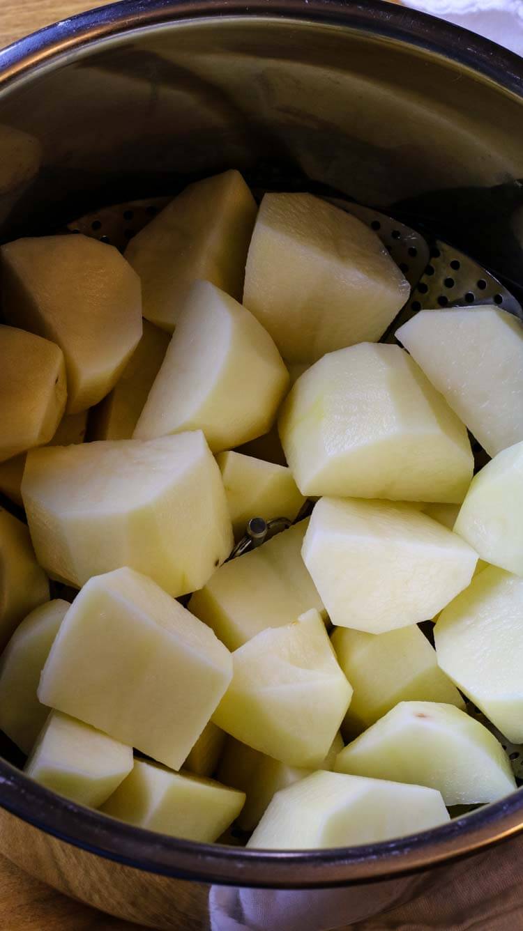 Peeled and cut russet potatoes in Instant Pot liner.