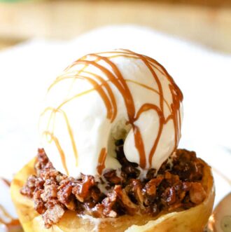 Apple halves topped with pecan crumble and ice cream scoop