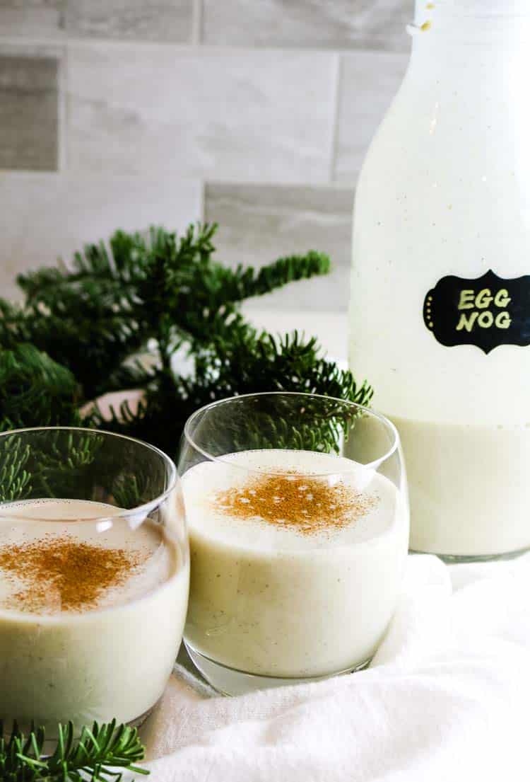 Eggnog in glasses with pine branches in the background