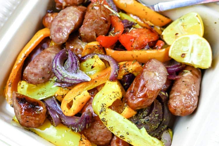 Sausage and bell peppers with red onions in a dish