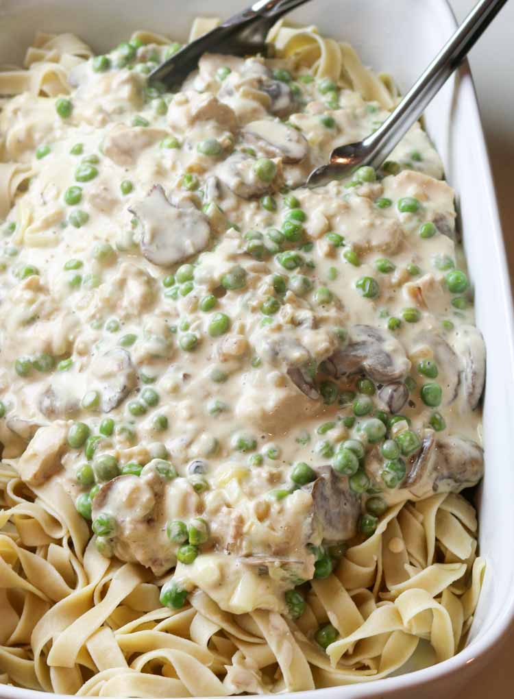 Tuna casserole filling with peas, onions, and mushrooms tossed with egg noodles