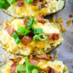 Close up of baked potatoes with bacon and green onions