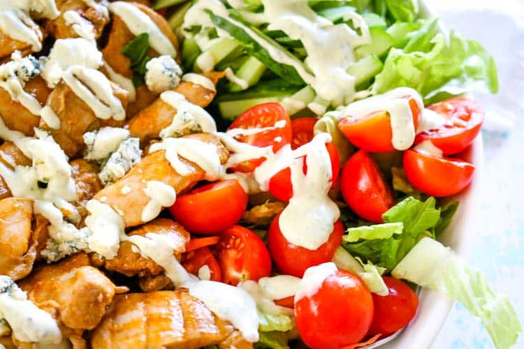 Creamy blue cheese dressing drizzled over buffalo chicken dressing