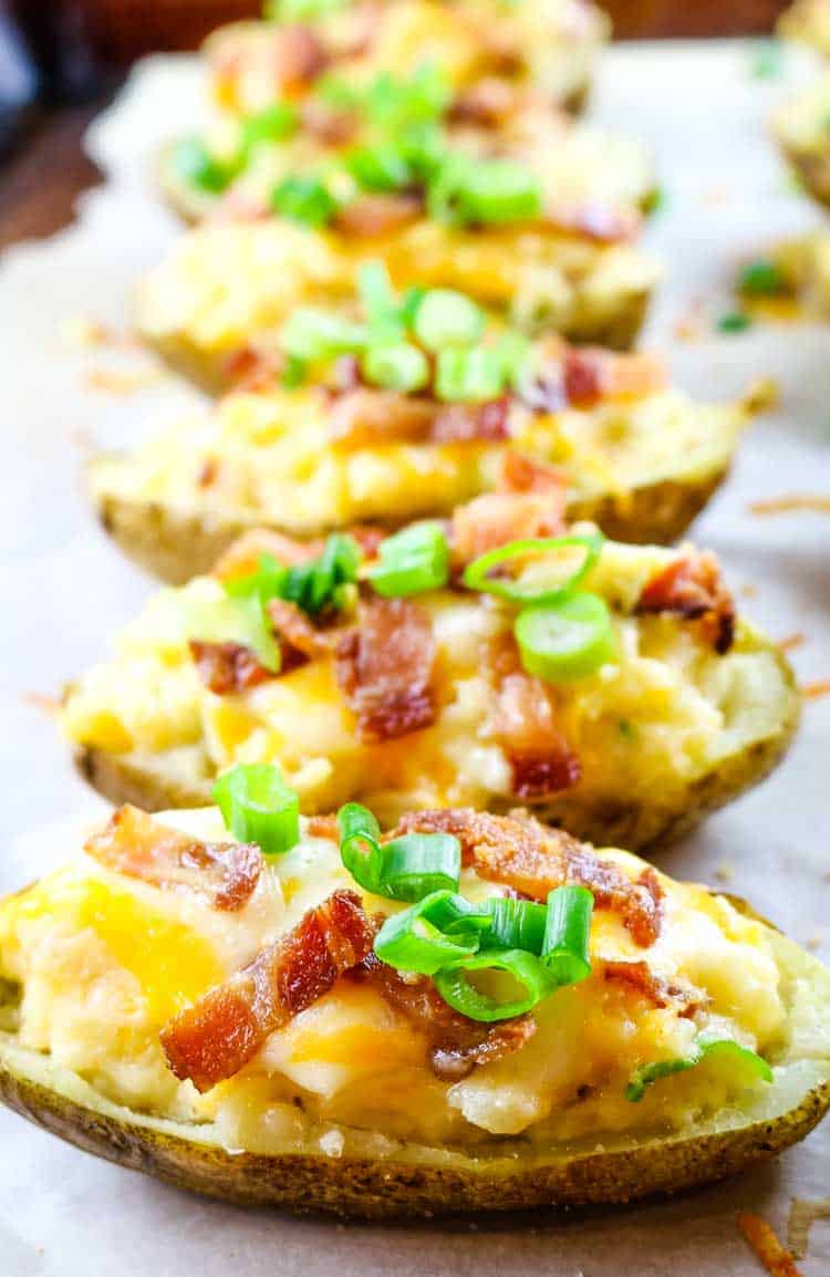 Potatoes with Bacon and Cheese on baking sheet with green onions