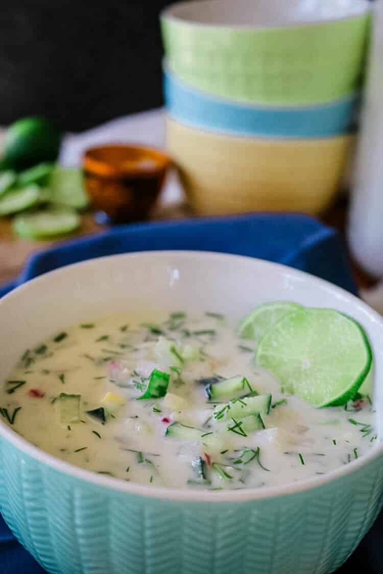 Okroshka in a bowl with a lime slice