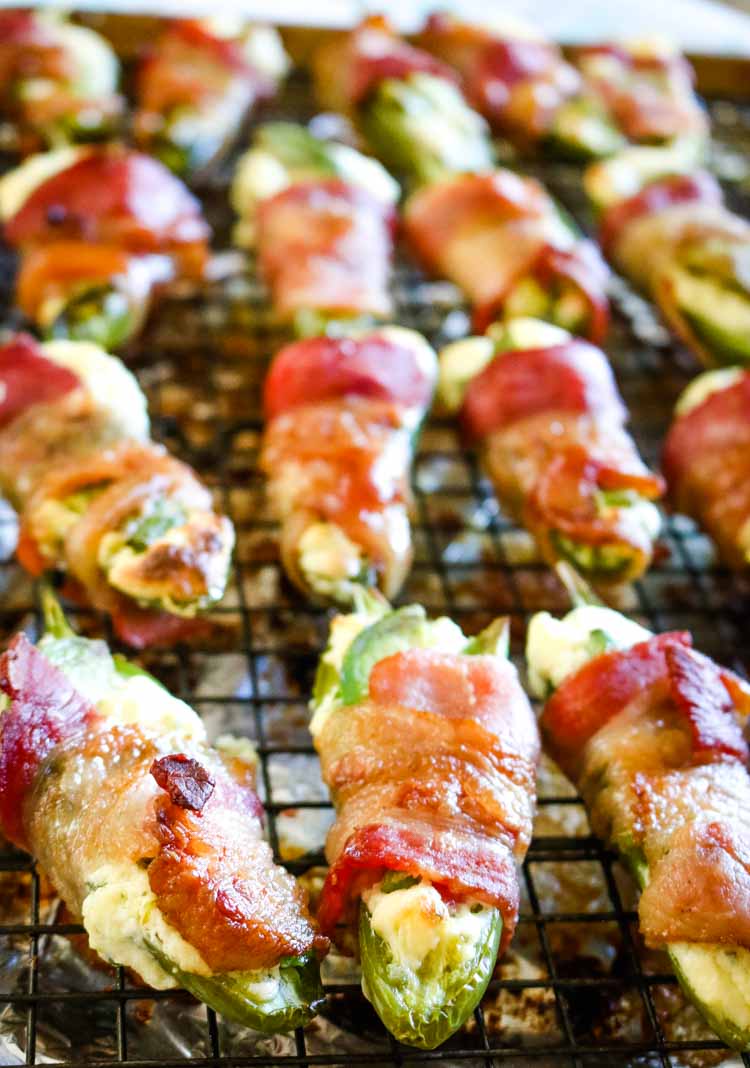 Bacon wrapped jalapeno peppers with cream cheese filling and avocado slices