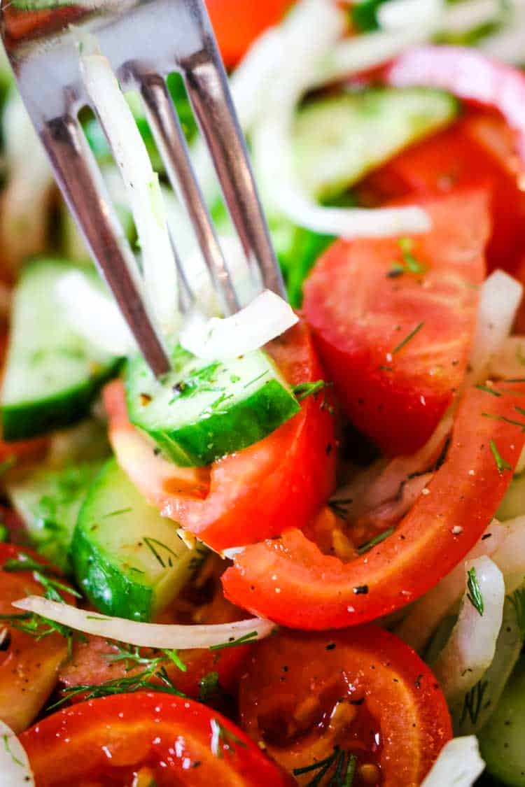 Cucumber Tomato and Onion Salad on a fork