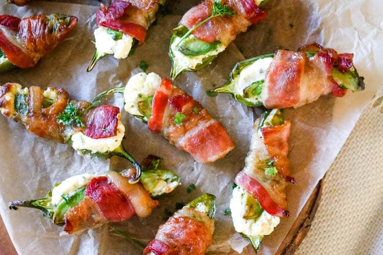 Keto Jalapeno Poppers on a platter with bacon and avocado