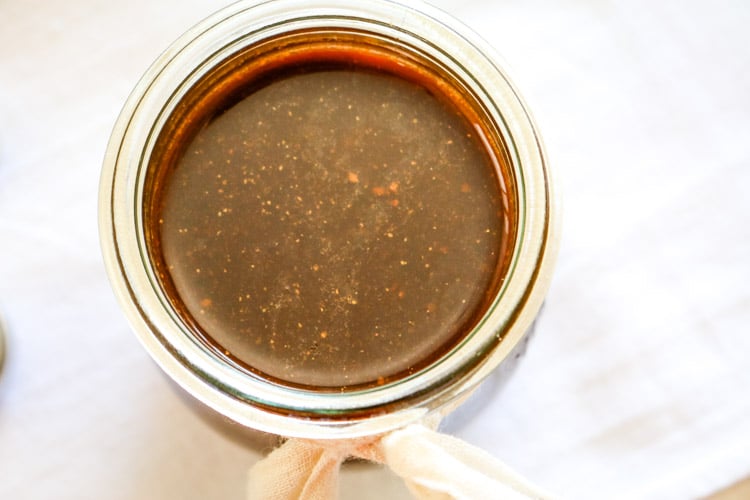 Homemade worcestershire sauce in a small jar with a small tie wrapped around
