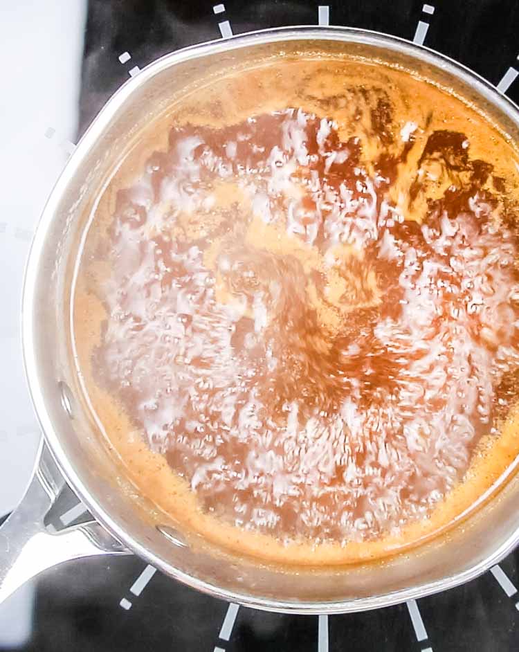 Homemade worcestershire sauce gently simmering in a medium saucepan