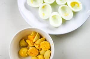 Small bowl with egg yolks and platter with egg whites separated.