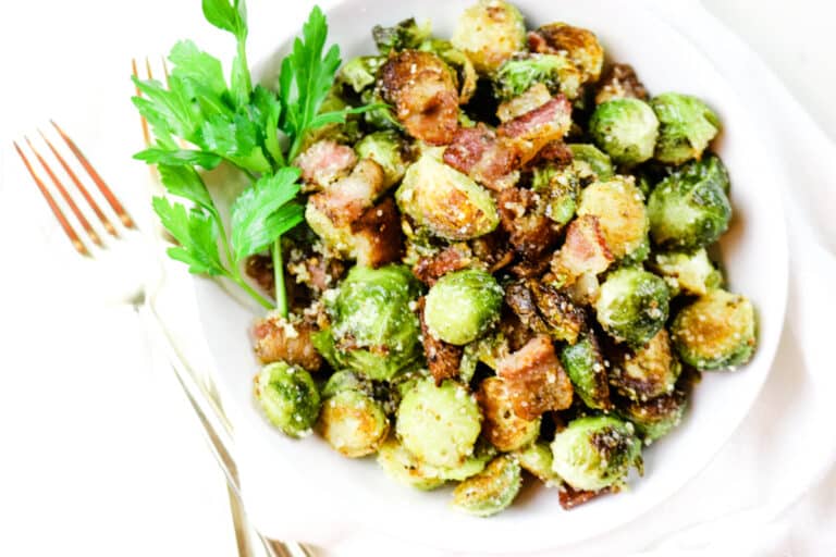 Brussel Sprouts roasted with bacon on white platter