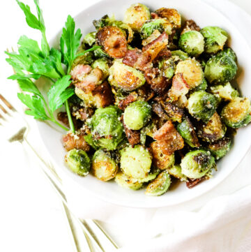Roasted Brussels sprouts with bacon in a white bowl