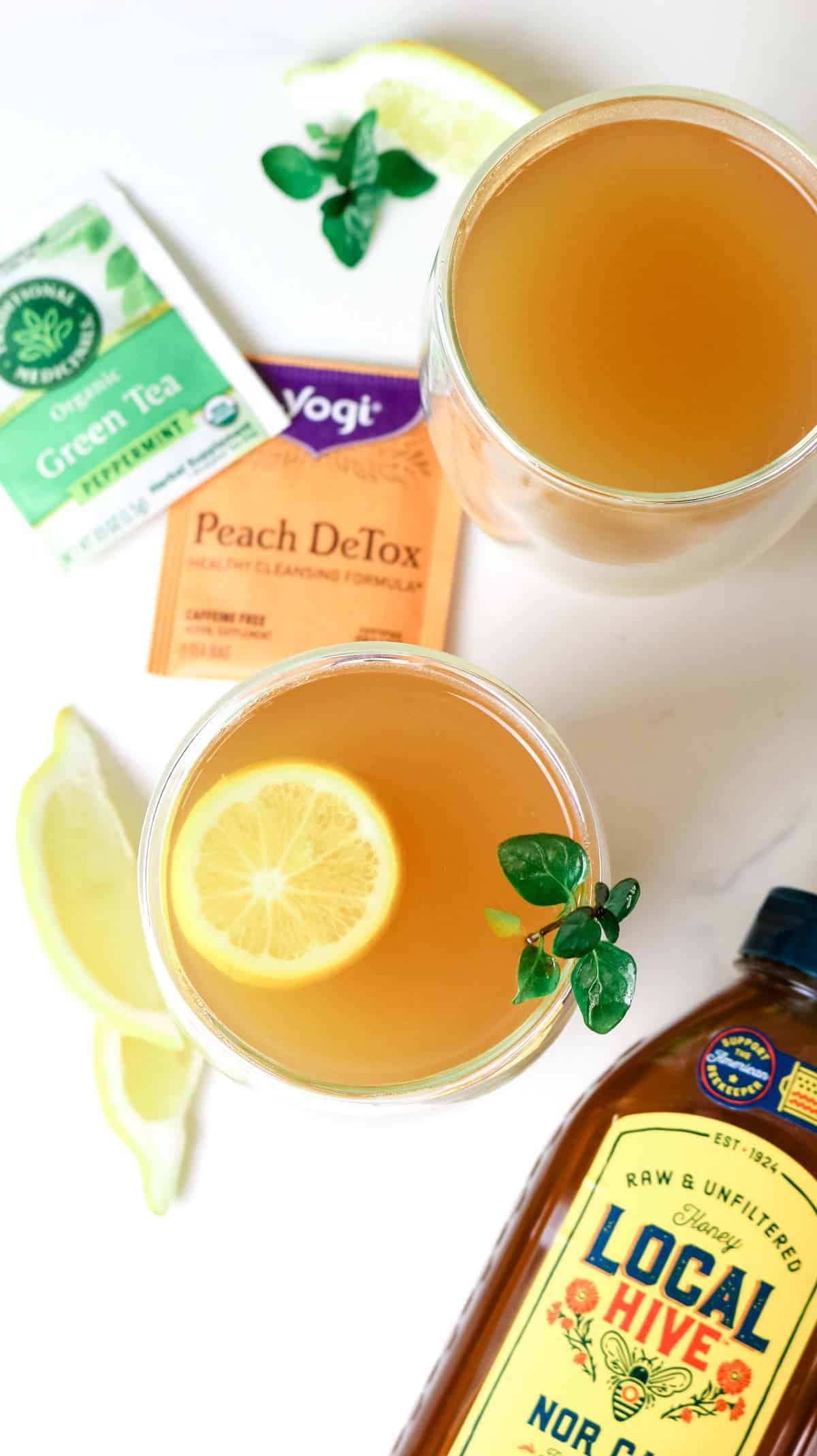 Overhead photo of Honey Citrus Mint Tea with honey, lemon, and organic teas