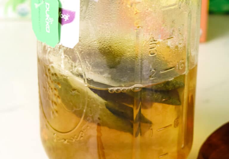 Step 1 to Honey Citrus Mint Tea is steeping organic teas in a large jar or mug.