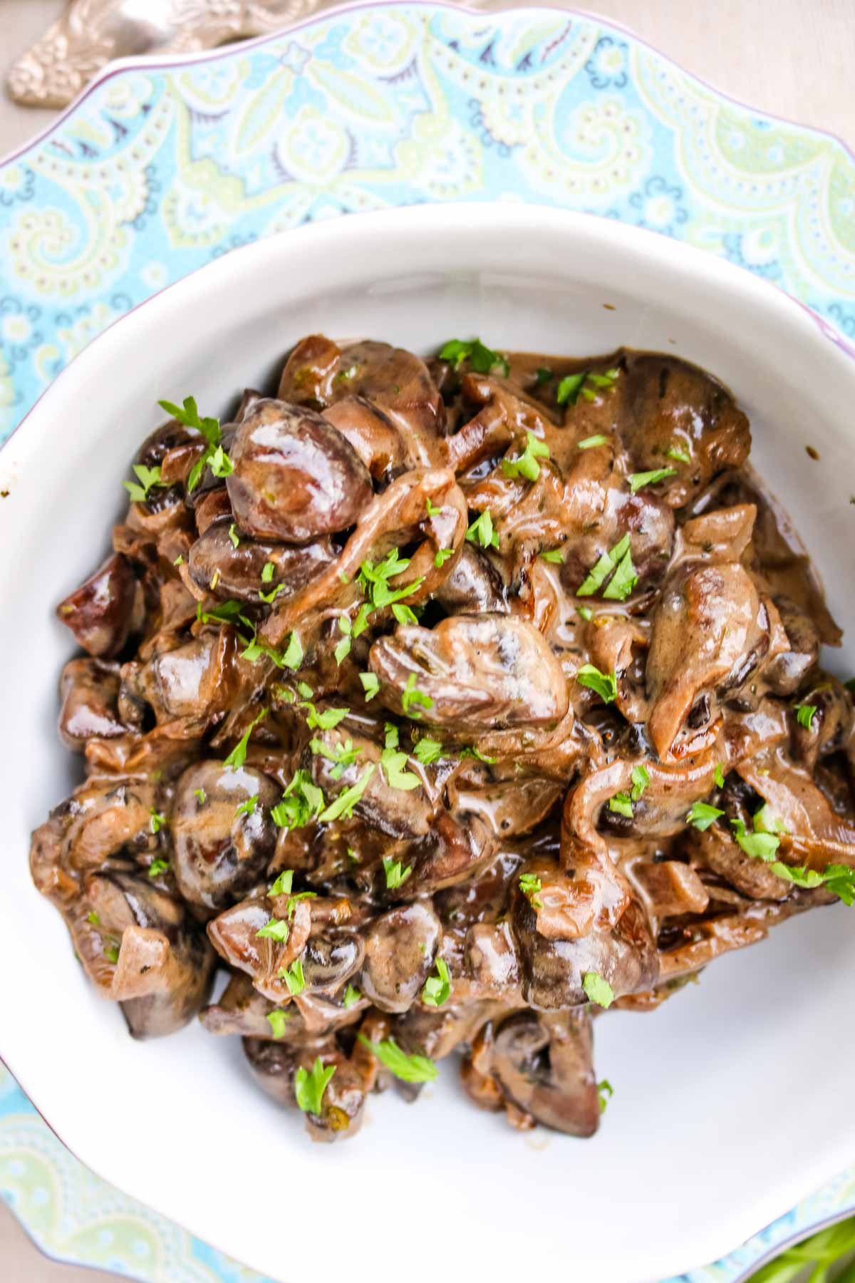 Creamed Mushrooms in a pretty floral bowl with parsley garnish