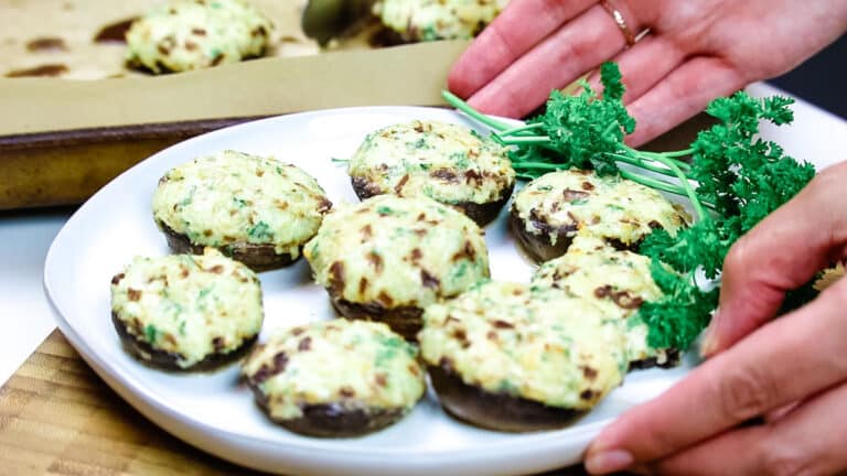 Easy stuffed mushrooms on a white plate being served