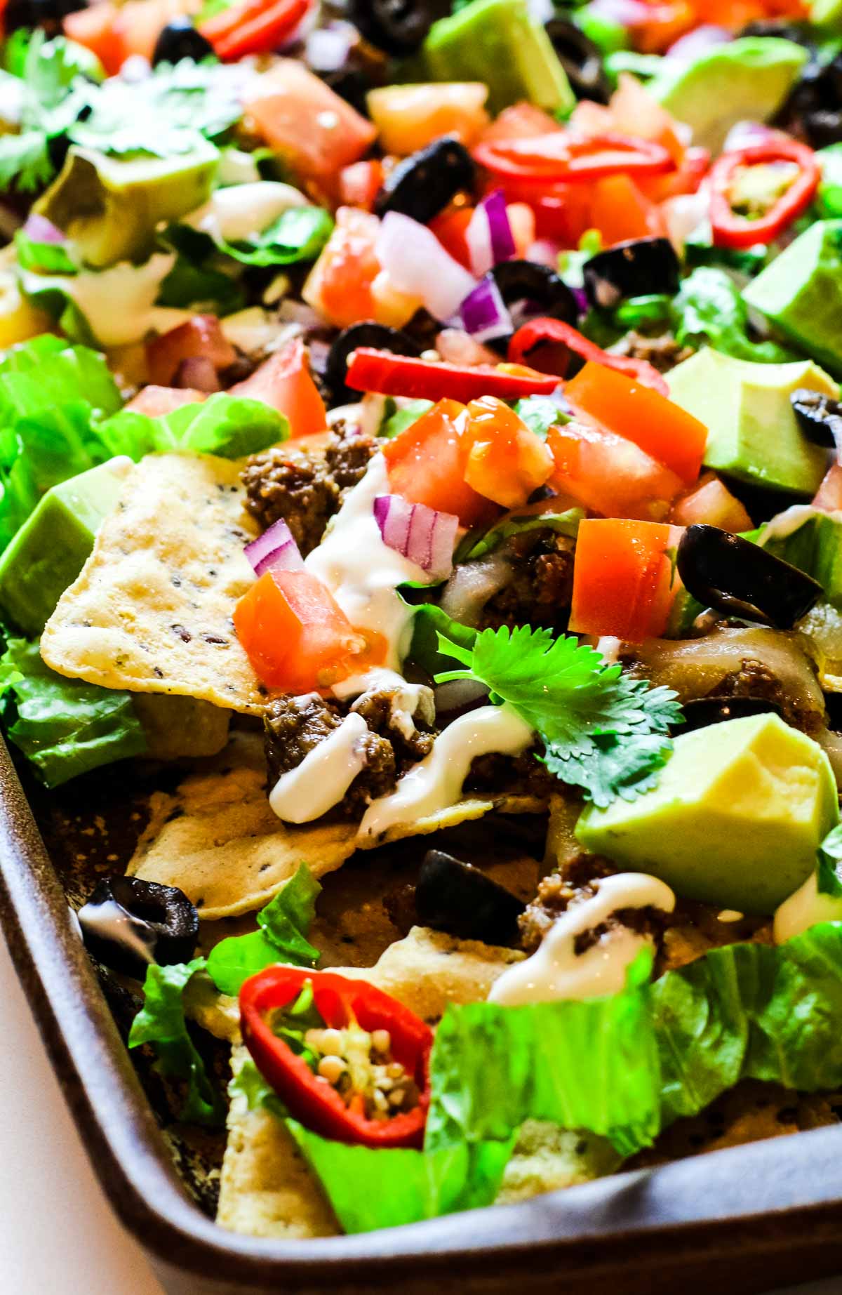 sheet pan nachos with taco meat and vegetables