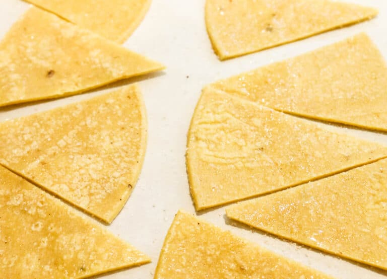 tortilla wedges spread on sheet pan for baking