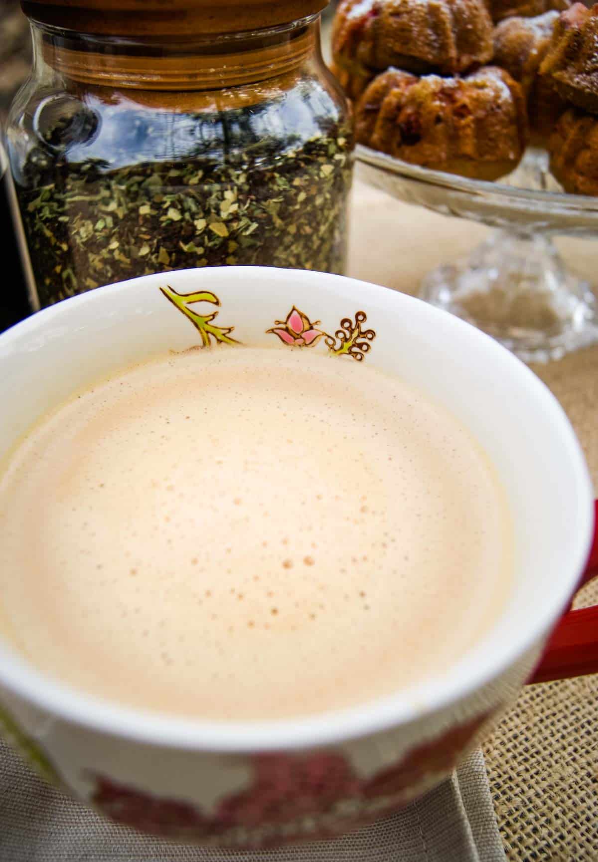 Herbal coffee in a mug with herbal coffee blend in jar in background