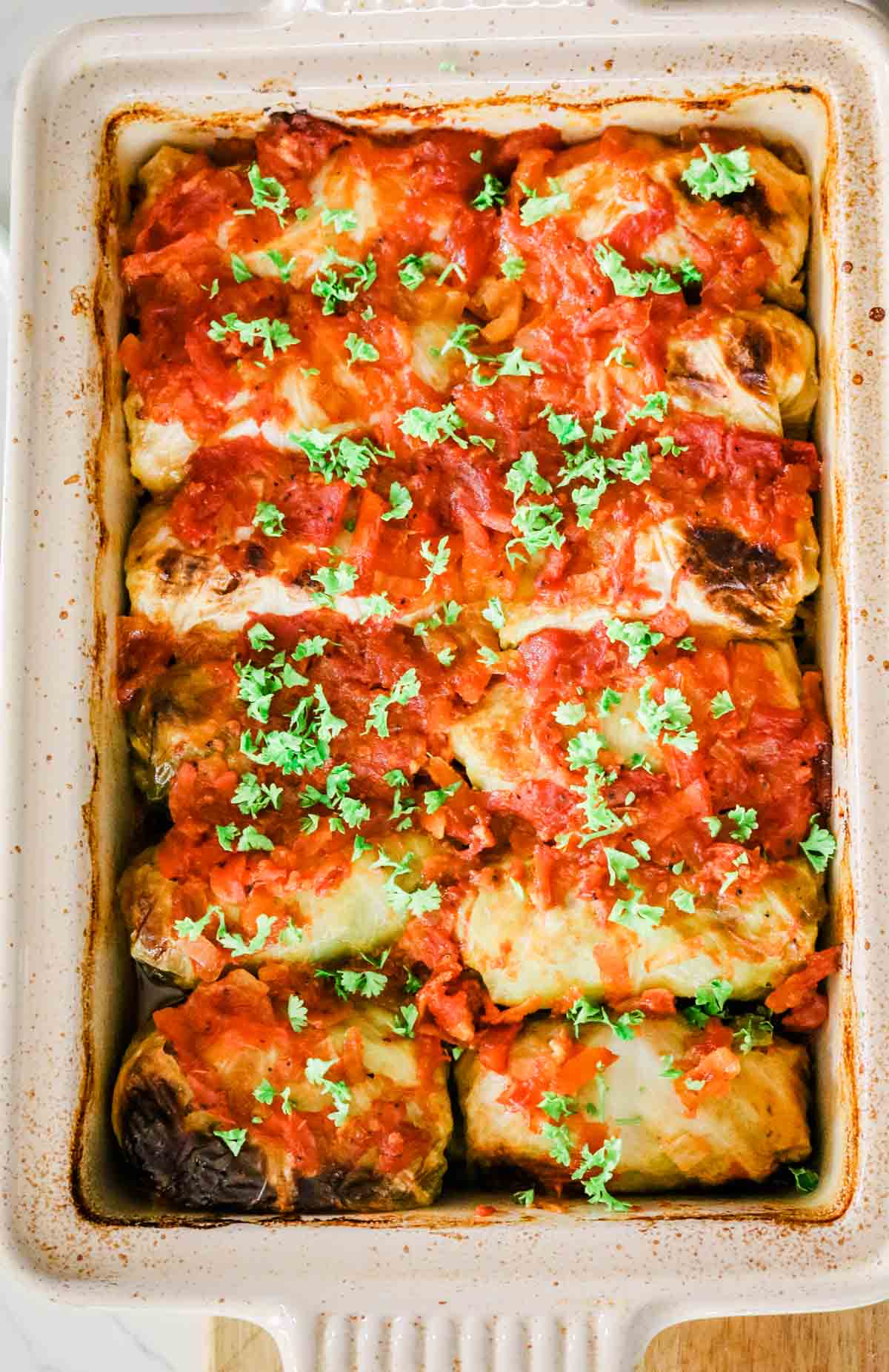 cabbage rolls lined up in a casserole dish
