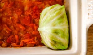 one cabbage roll in a casserole dish