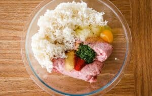 glass bowl with ground meat and rice and seasonings