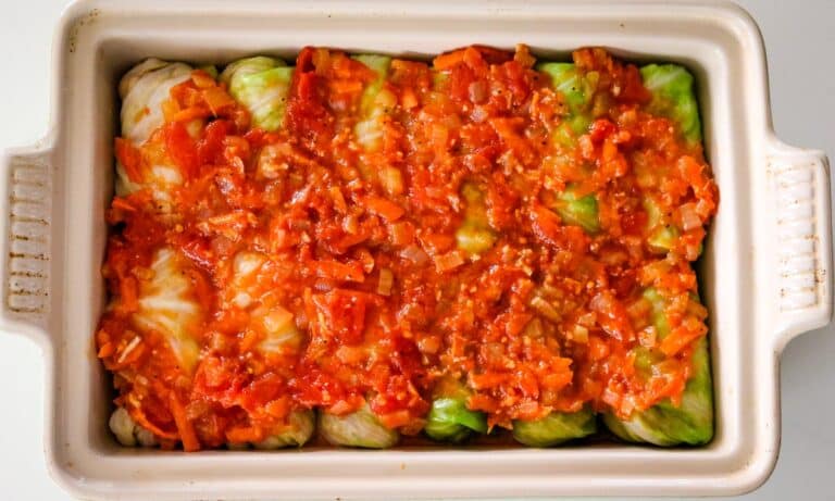 baking dish with cabbage rolls and tomato sauce