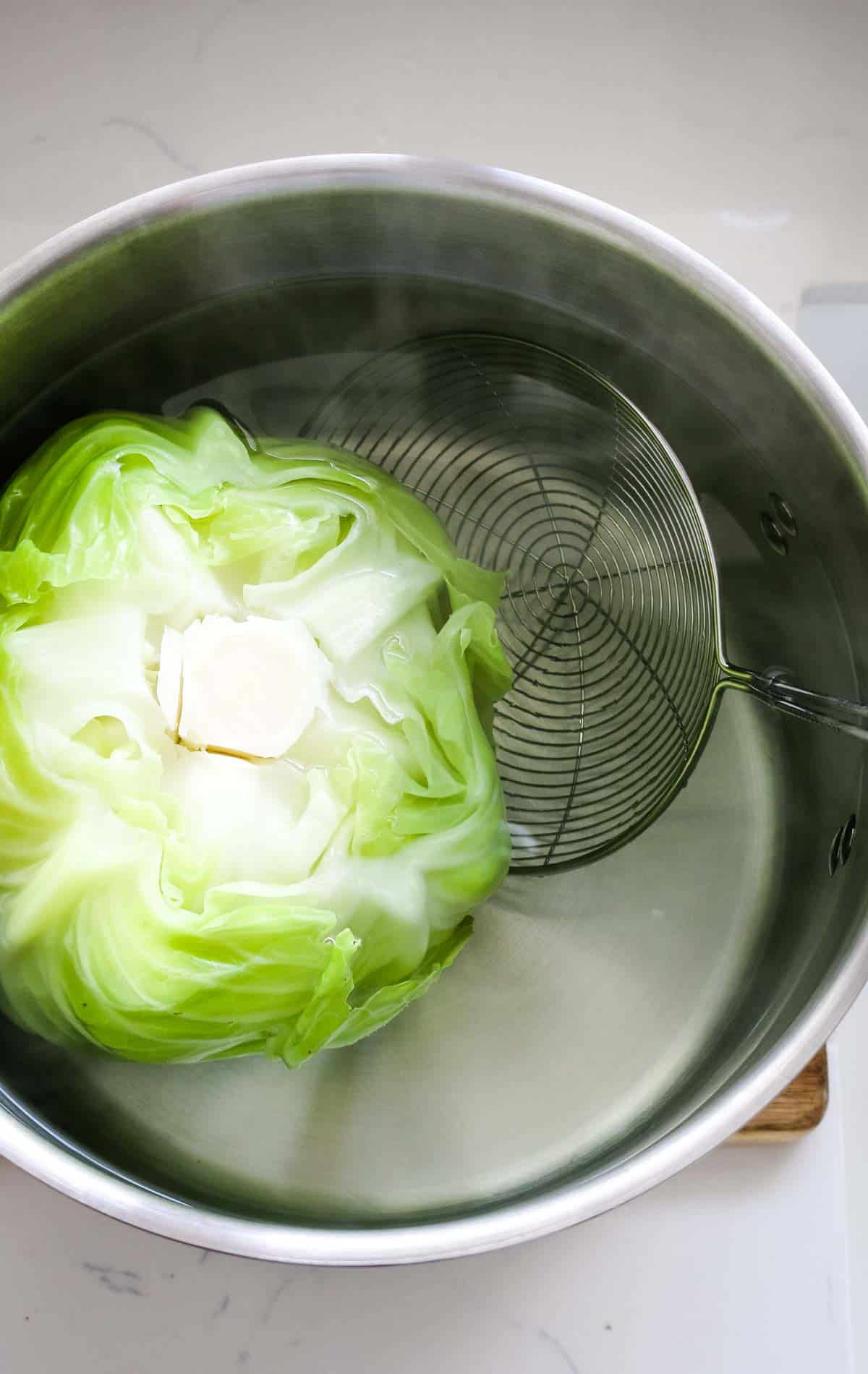 pot with green cabbage and strainer