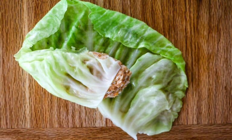 halfway wrapped cabbage leaf over meat mixture