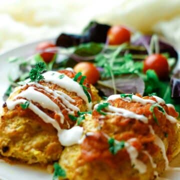 lazy cabbage rolls drizzled with sour cream on white plate