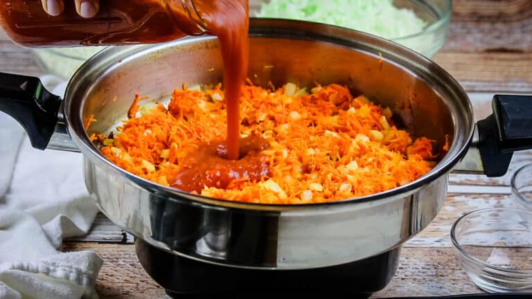 Sauteeing carrots and tomato sauce with onions