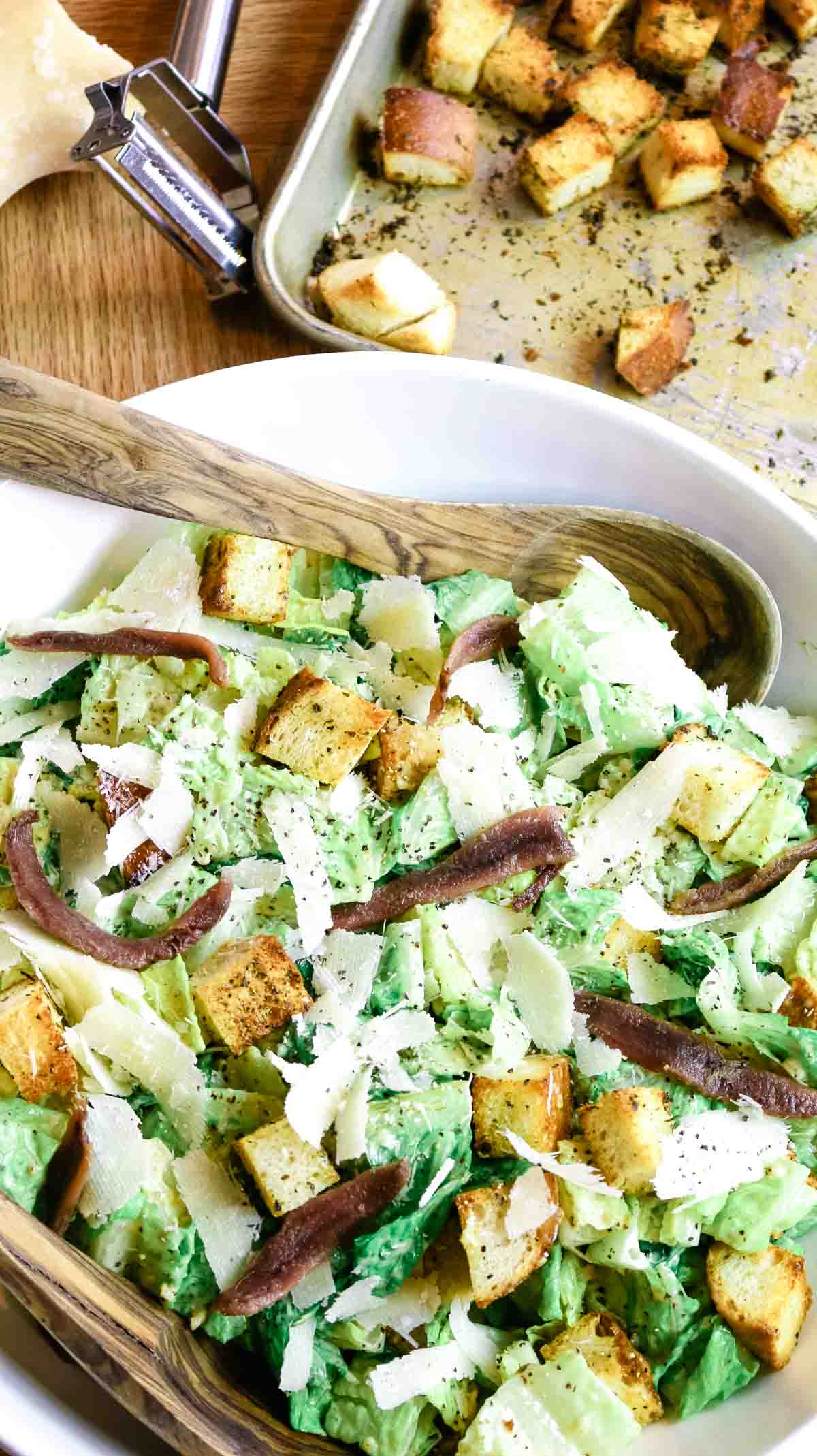 caesar salad with croutons on baking sheet