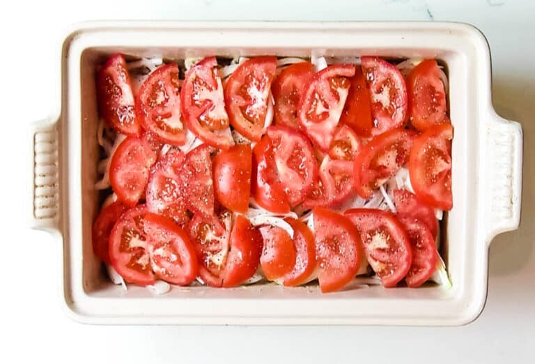 sliced tomatoes in a casserole dish