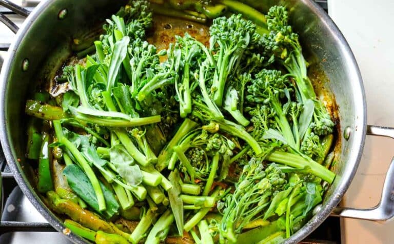 broccoli and bell peppers in deep stainless steel pan