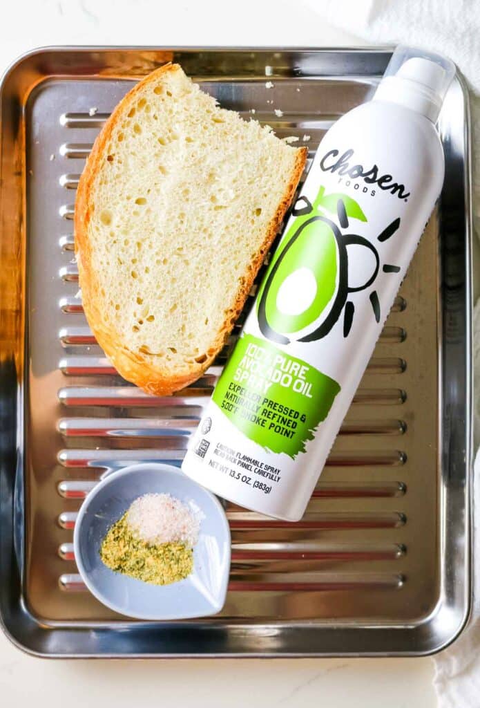flat lay of leftover bread with avocado oil spray and seasonings.