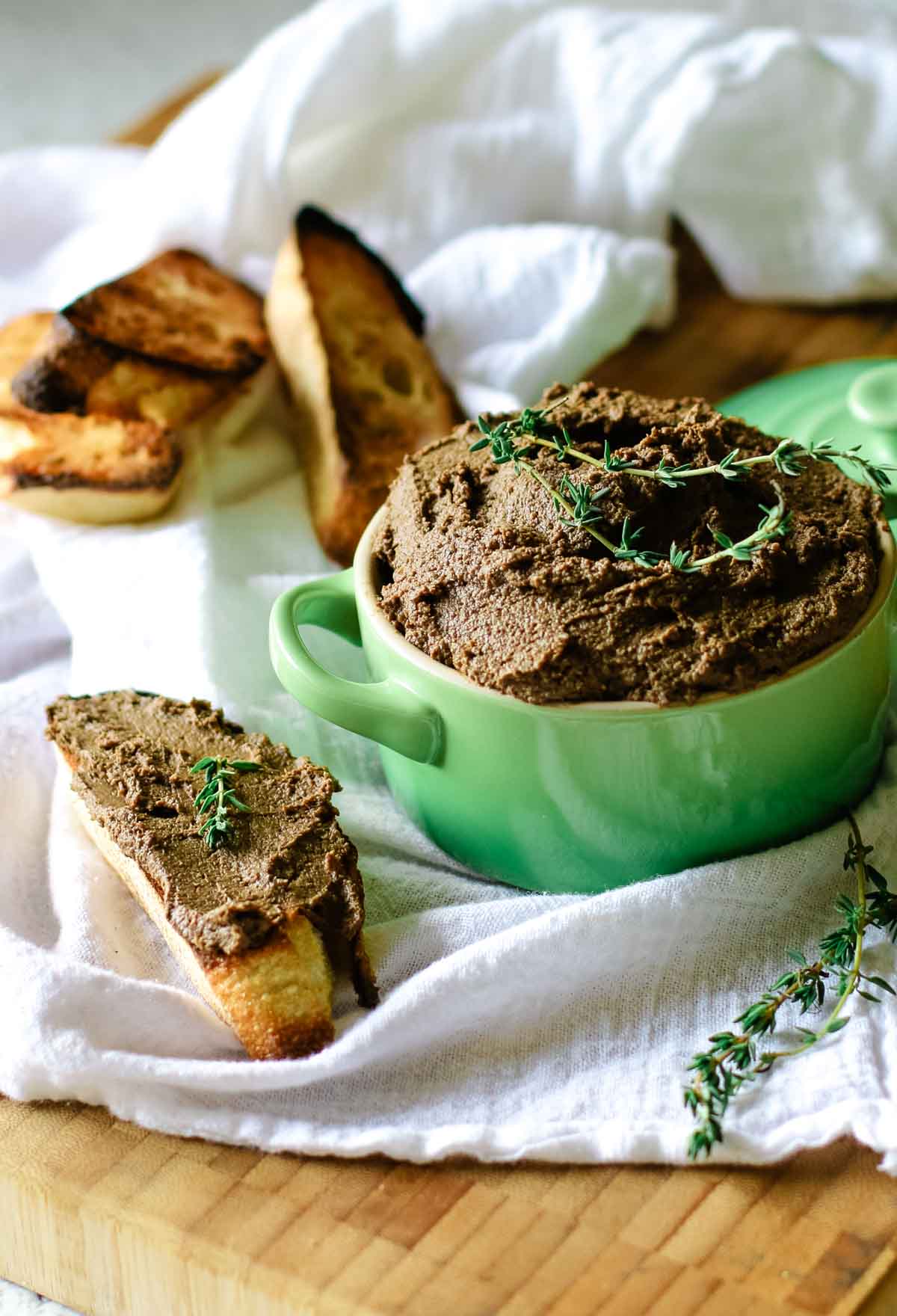 beef liver pate in a ramekin with sourdough bread