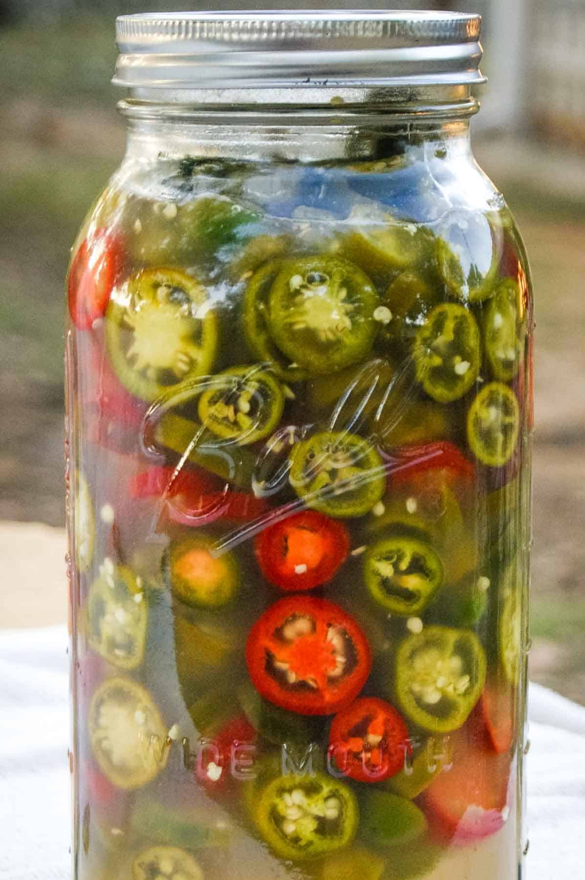 half gallon mason jar with sliced jalapenos